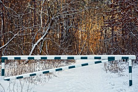 iron barrier on a road in the snowの写真素材