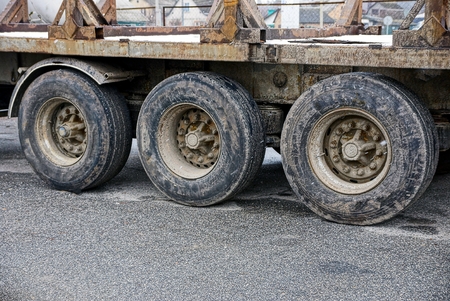 three large trailer truck wheels on the asphaltの写真素材