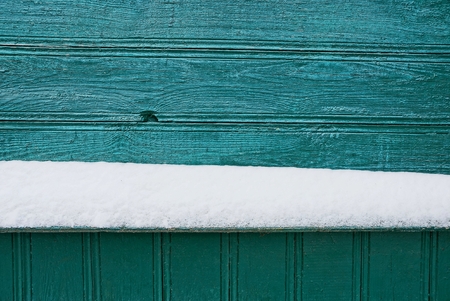 wooden texture of green wall boards and white snowの写真素材