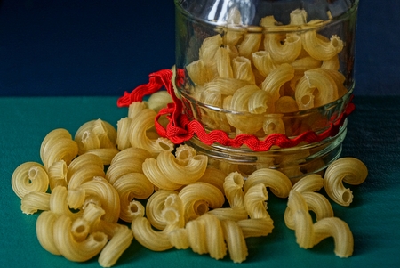 yellow dry pasta and a glass jarの写真素材