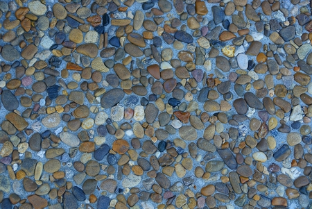 colored pebbles and crushed stone in the cement on the foundationの写真素材