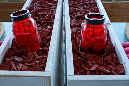 two red glass jars stand in a bark in boxesの写真素材