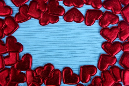 red small hearts on a blue paper background