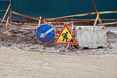 road works on the road with a pit and road signs