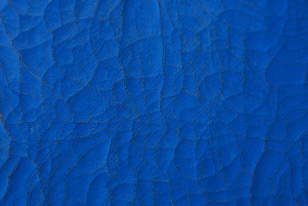 blue leather texture of a piece of padding with cracks