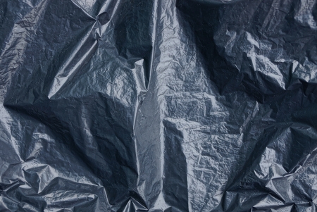 plastic texture of a piece of crumpled black cellophane