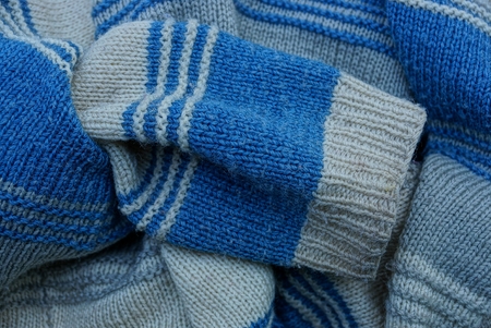 blue gray woolen texture of a sweater with a sleeveの写真素材