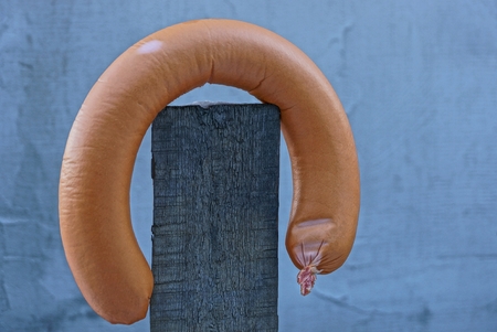 brown sausage on a gray fence boardの写真素材