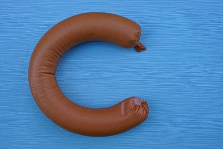 piece of brown sausage on a blue table