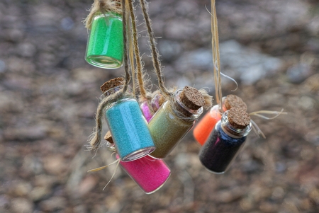 small bottles with colored sand hang on stringの写真素材