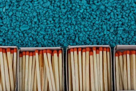 Open boxes with matches on a blue stone backgroundの写真素材