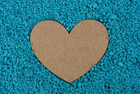 a large wooden heart in small blue stonesの写真素材