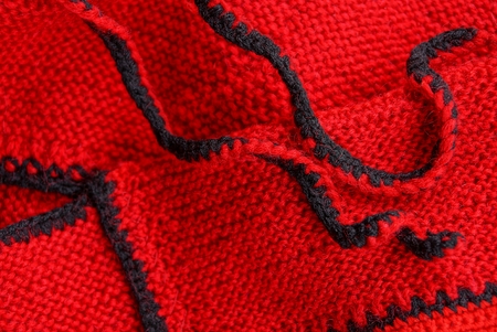 red black texture of woolen cloth from clothesの写真素材
