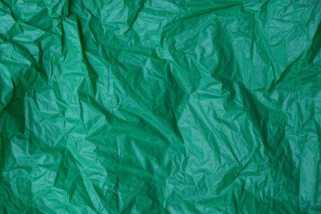 plastic texture of a piece of crumpled green cellophaneの写真素材
