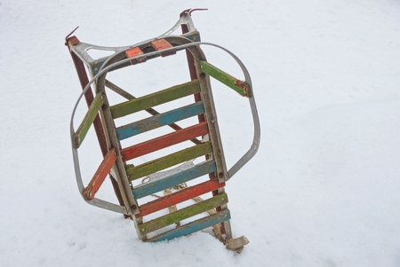Old colored sledges in the snowdrift of white snow on the streetの写真素材