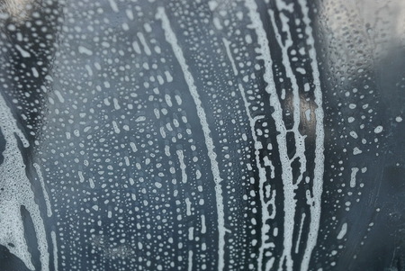 texture of wet glass in white foamの写真素材