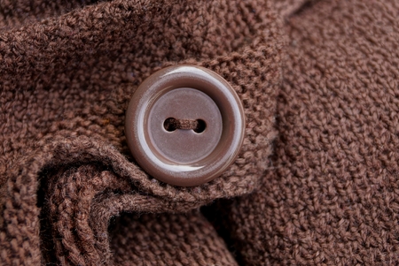 large brown button on a piece of woolen clothes