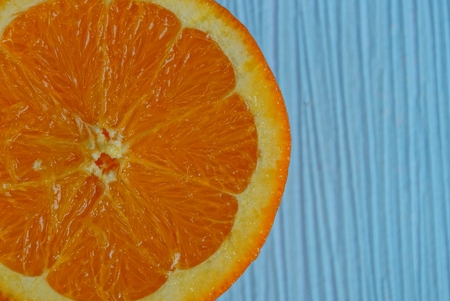 ripe raw orange on a blue tableの写真素材