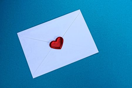 white closed envelope with a red heart on a blue background