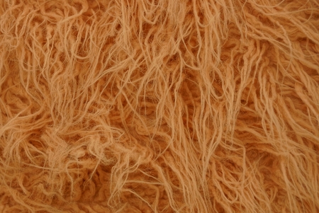 Texture of long wool of orange color of a piece of clothingの写真素材