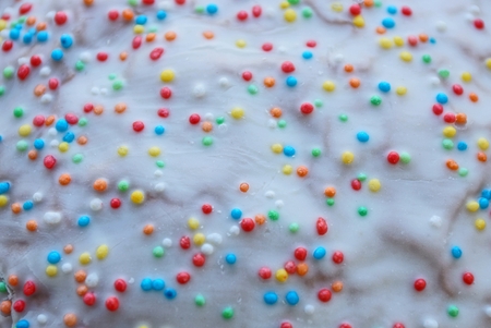 Colored background of sweet powder on a cake