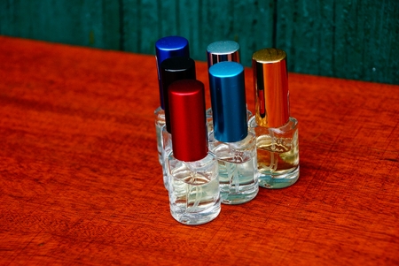 set of colored bottles on a red tableの写真素材