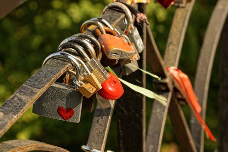 padlocks on steel fence rods on the street