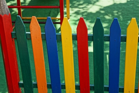 colored decorative fence from boards at a children playgroundの写真素材