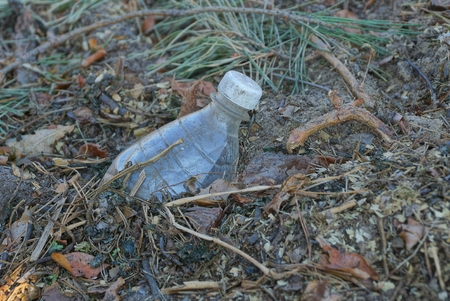 old gray plastic bottle on the floor background.