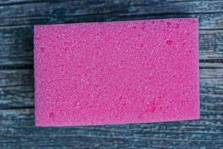 one red foam sponge on the tableの写真素材