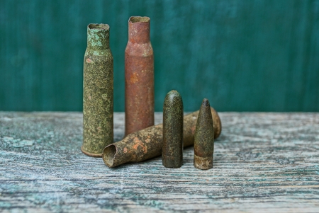 set of old color bullets and sleeves on a gray tableの写真素材