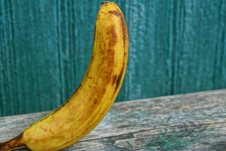 big yellow banana peel on a gray tableの写真素材