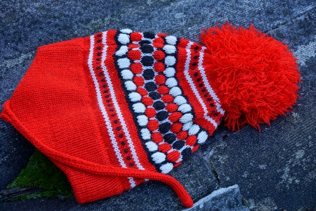 pompon lies on gray asphalt
