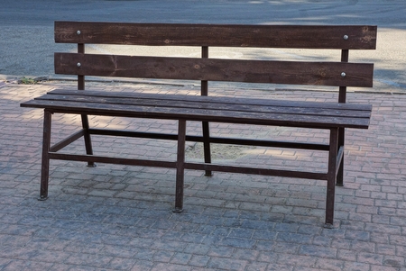 one brown wooden bench stands