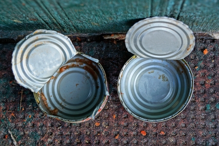 two empty open dirty cans on the tableの写真素材
