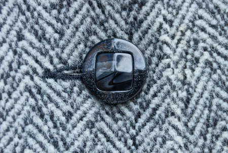 black button on woolen striped woolen clothes