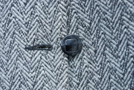 one black button on woolen striped woolen clothes