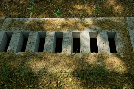 concrete drainage on the sidewalk in the park