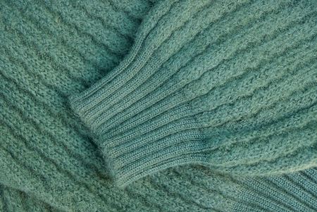green fabric texture woolen sweater with sleeves