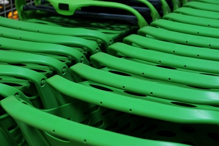 green texture from a row of plastic carts in a supermarketの写真素材