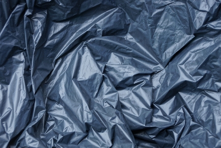plastic texture of black cellophane on a crumpled bagの写真素材