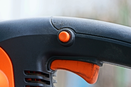 button on a black plastic handle