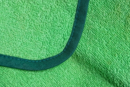 green fabric background from a piece of woolen clothes with a seamの写真素材