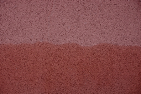 brown plaster background with a pattern on the wallの写真素材