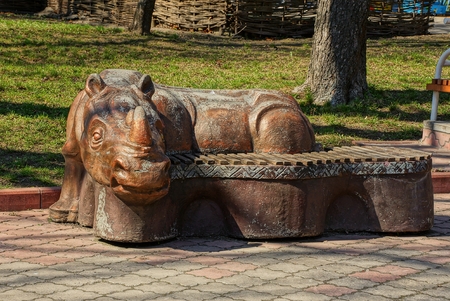 one brown bench with a rhino figureの写真素材