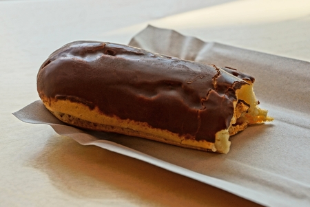 brown chocolate choux pastry on a gray paper plateの写真素材