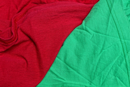red green fabric texture from a piece of crumpled matter on clothesの写真素材