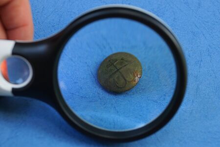 black green brass button on blue table