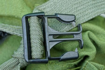 green harness on a backpack fabric