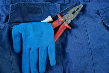 blue work glove and tools in your pants pocketの写真素材